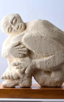 Man hugging his legs by Eitan Froumine